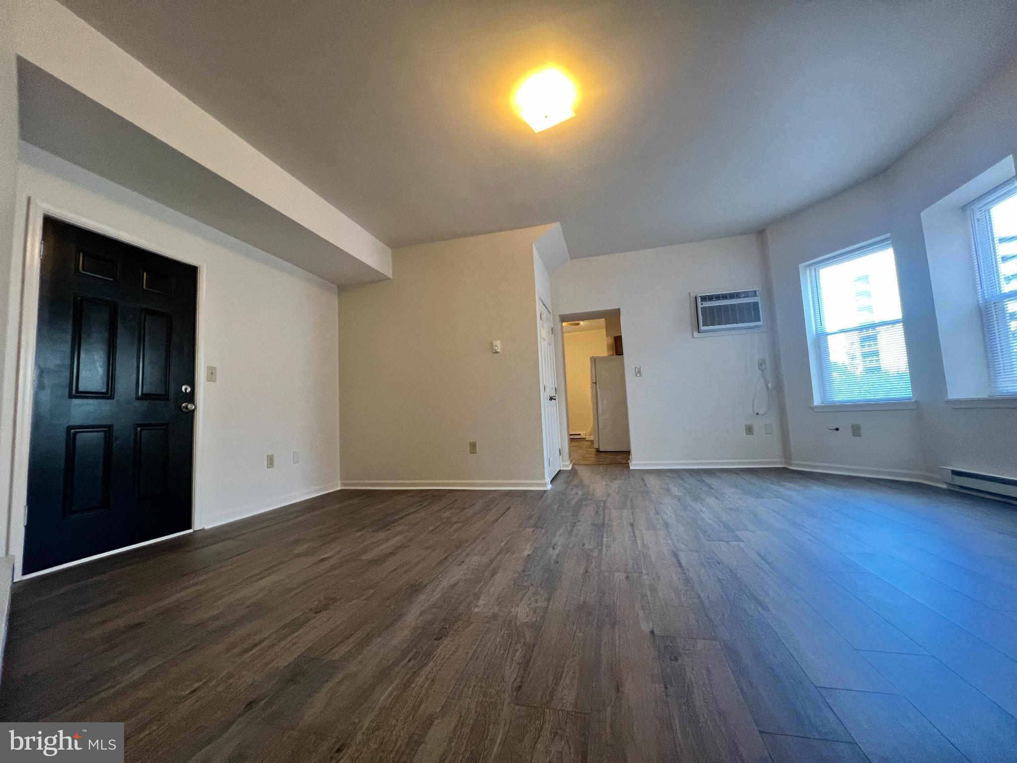 255 South Potomac Street, Unit 2 Hagerstown, MD 21740 - Photo 3 of 18 an empty room with wooden floor and windows