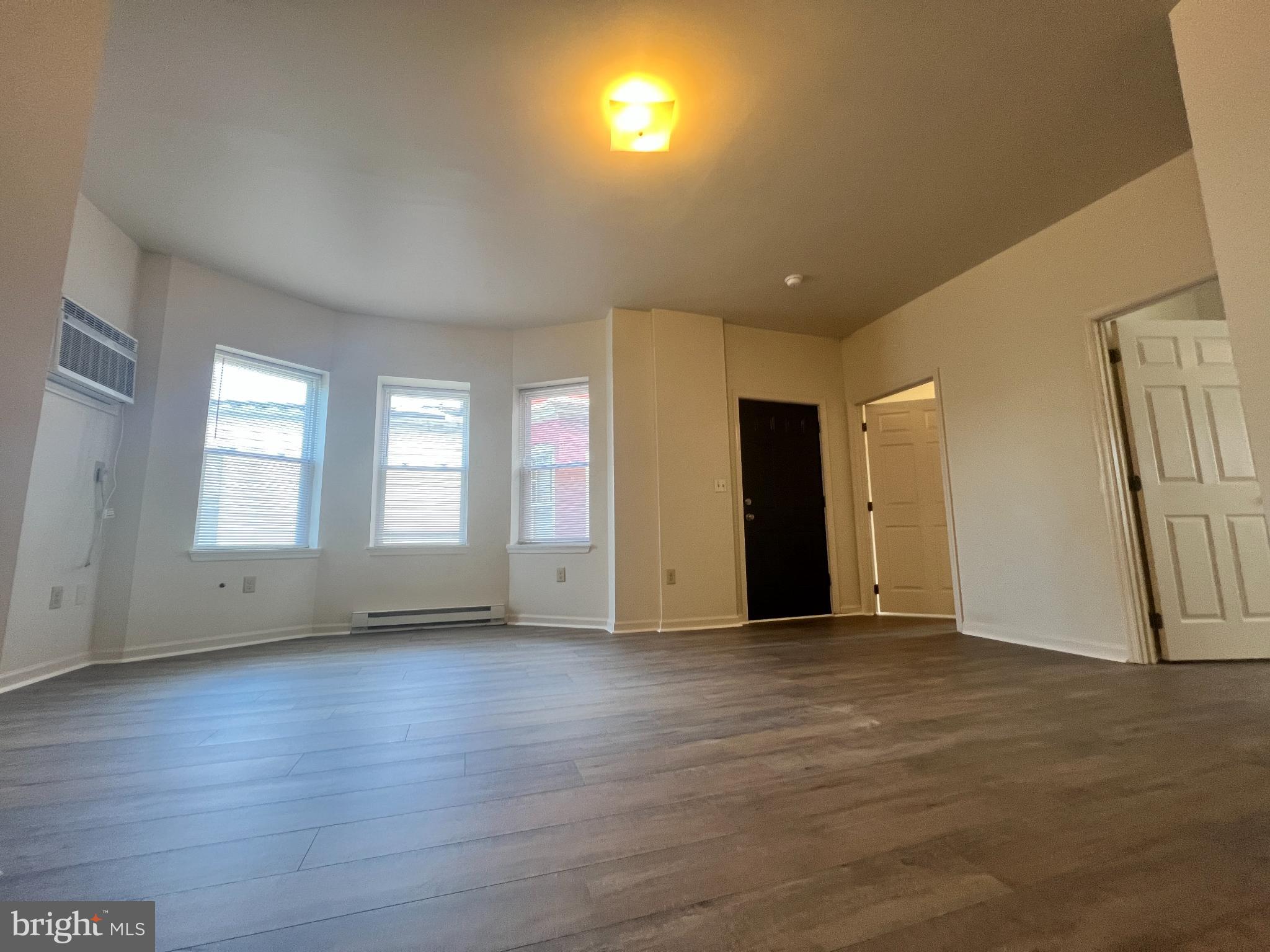 255 South Potomac Street, Unit 2 Hagerstown, MD 21740 - Photo 4 of 18 a view of an empty room with wooden floor and a window