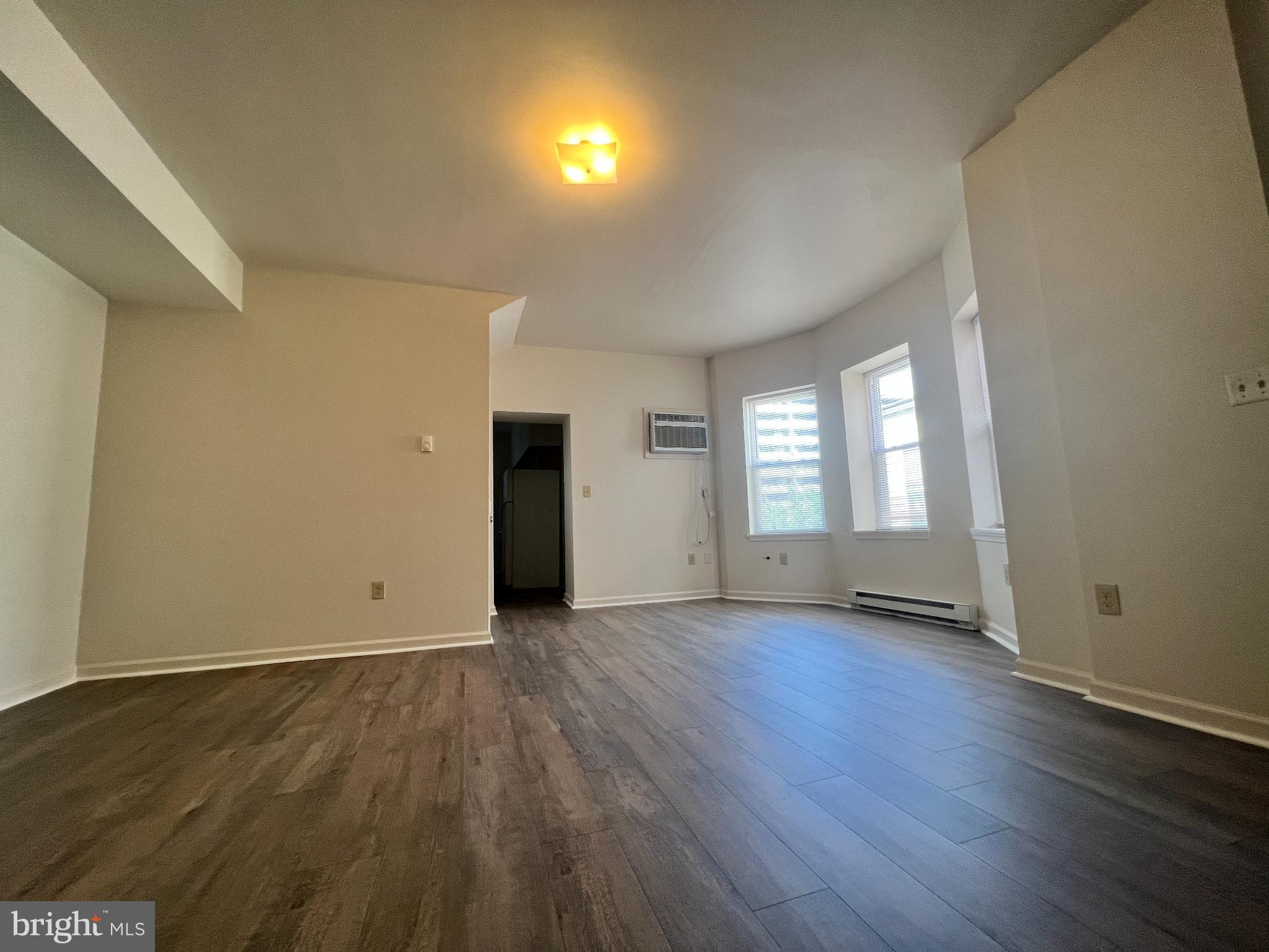 255 South Potomac Street, Unit 2 Hagerstown, MD 21740 - Photo 6 of 18 an empty room with wooden floor and windows