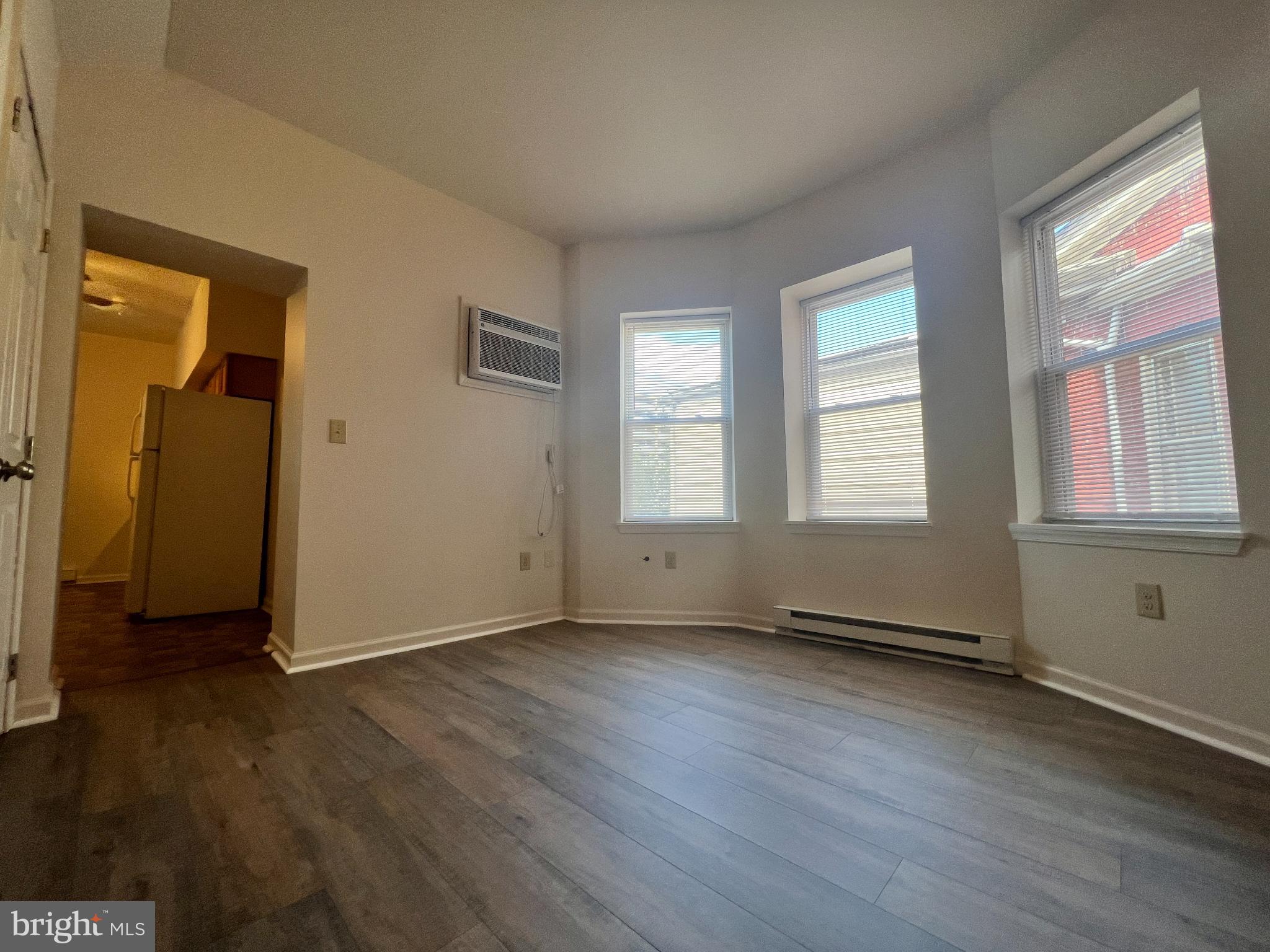 255 South Potomac Street, Unit 2 Hagerstown, MD 21740 - Photo 7 of 18 an empty room with wooden floor and windows