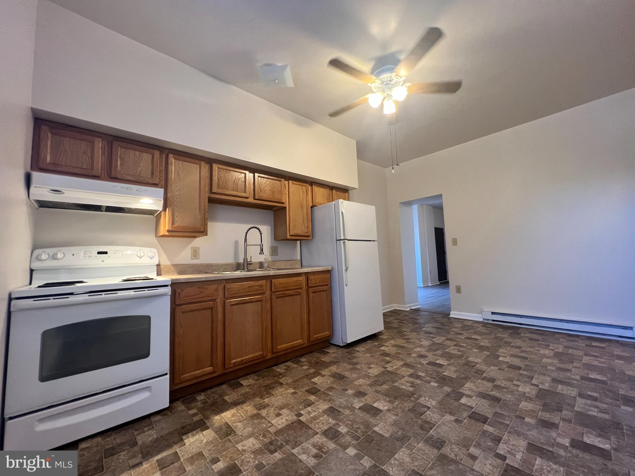 255 South Potomac Street, Unit 2 Hagerstown, MD 21740 - Photo 9 of 18 a kitchen with refrigerator and cabinets