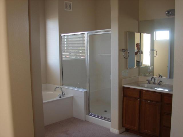 4488 East Thomas Road Phoenix, AZ 85018 - Photo 3 of 8 a bathroom with a granite countertop sink mirror and a bathtub