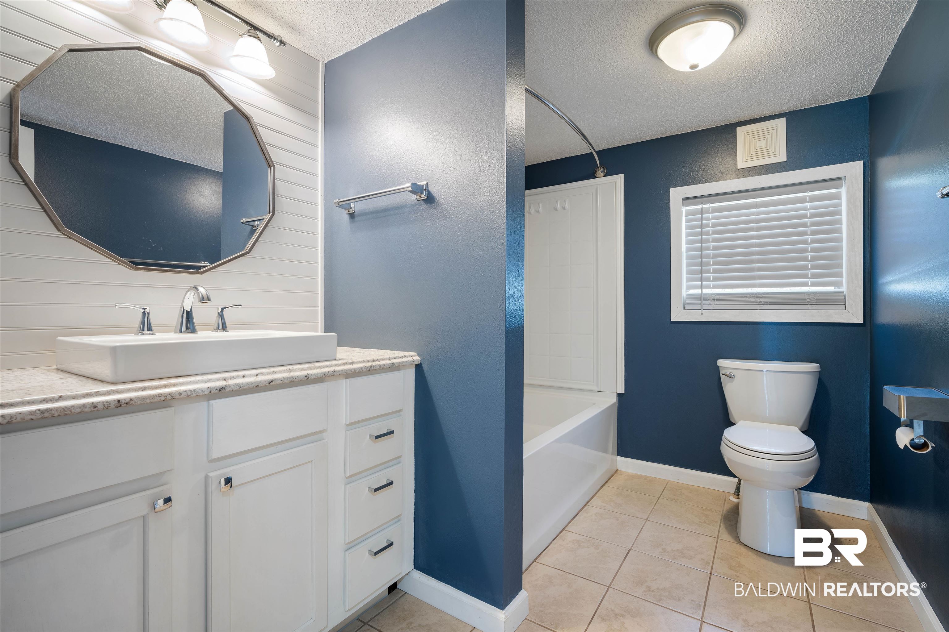 9011 Wilmer Georgetown Road Wilmer, AL 36587 - Photo 21 of 34 Bathroom with tile patterned floors, toilet, vanity, a textured ceiling, and visible vents