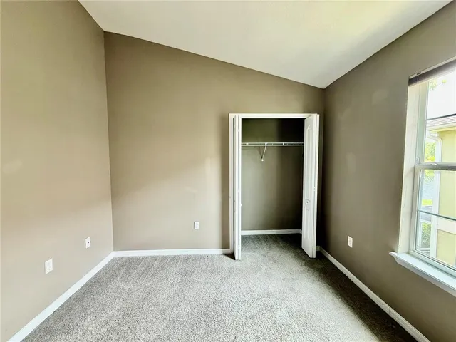 an empty room with windows and entrance