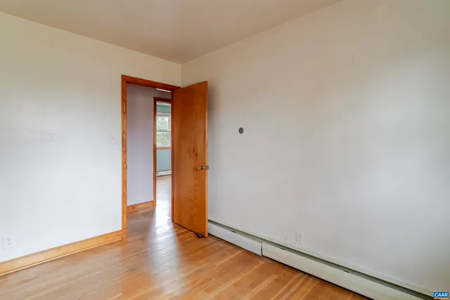a view of an empty room and wooden floor