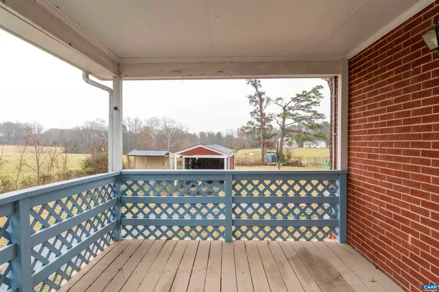 a view of a balcony with wooden floor
