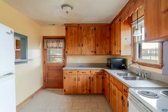 a kitchen with a sink stove and cabinets