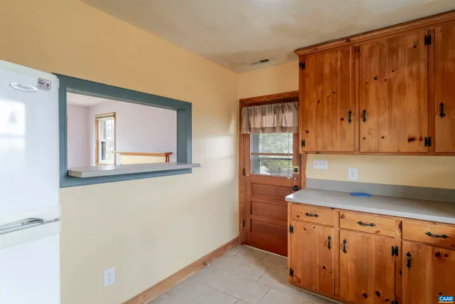 a kitchen with granite countertop cabinets and window