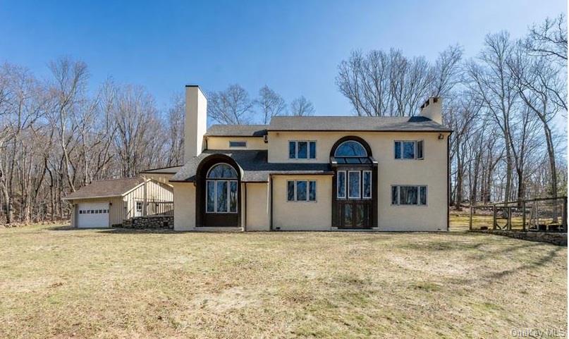 17 Highview Road Pound Ridge, NY 10576 - Photo 1 of 23 a view of a wooden house with a yard