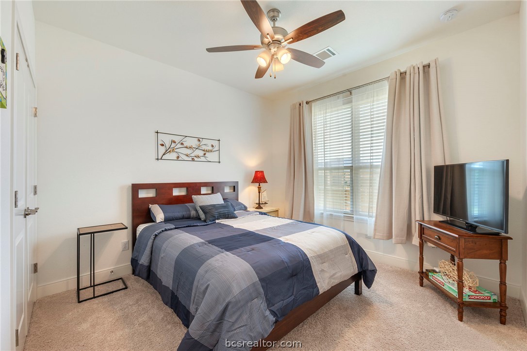 3500 Abingdon Cove Bryan, TX 77808 - Photo 12 of 23 a bedroom with a bed and a flat screen tv