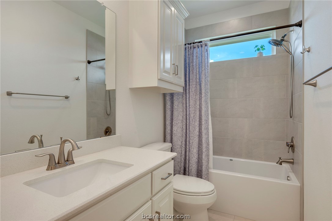 3500 Abingdon Cove Bryan, TX 77808 - Photo 13 of 23 a bathroom with a granite countertop sink toilet and shower