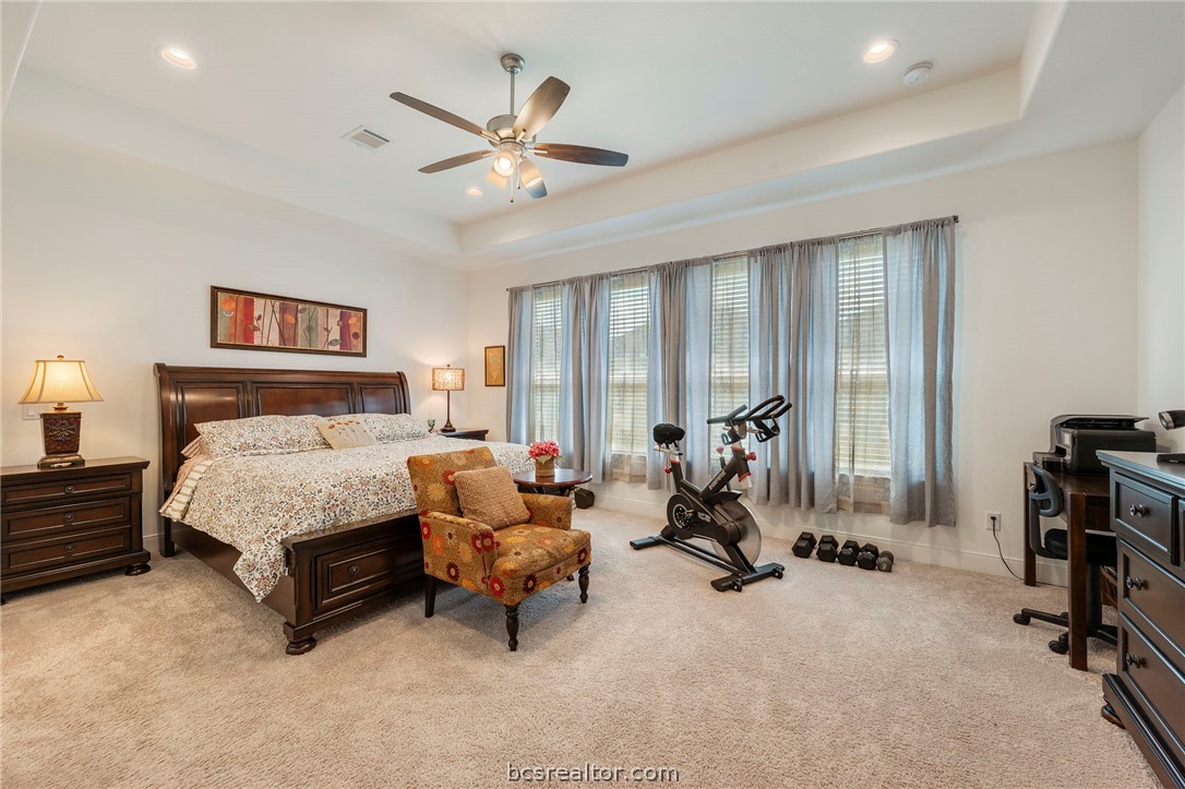 3500 Abingdon Cove Bryan, TX 77808 - Photo 9 of 23 a bed room with a bed and a chandelier