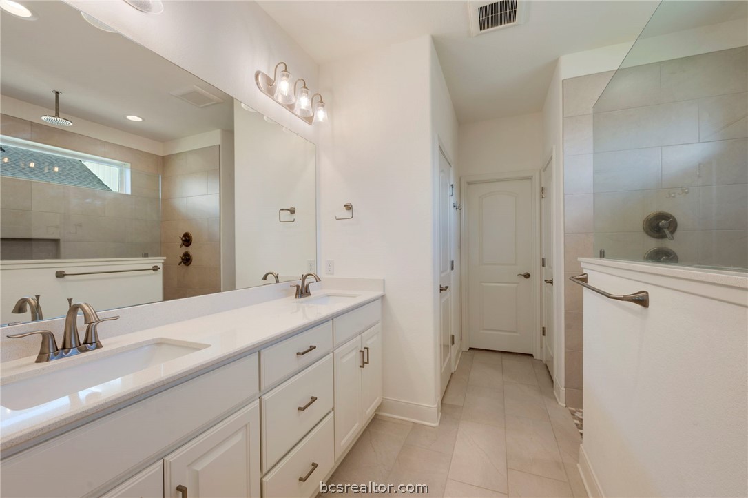 3500 Abingdon Cove Bryan, TX 77808 - Photo 10 of 23 a spacious bathroom with a double vanity sink mirror and shower