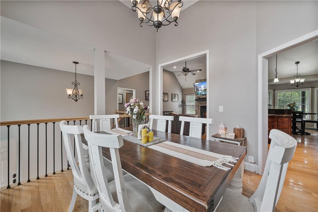 166 Woodford Way Southeast Calhoun, GA 30701 - Photo 13 of 44 a view of a dining room with furniture a chandelier and wooden floor