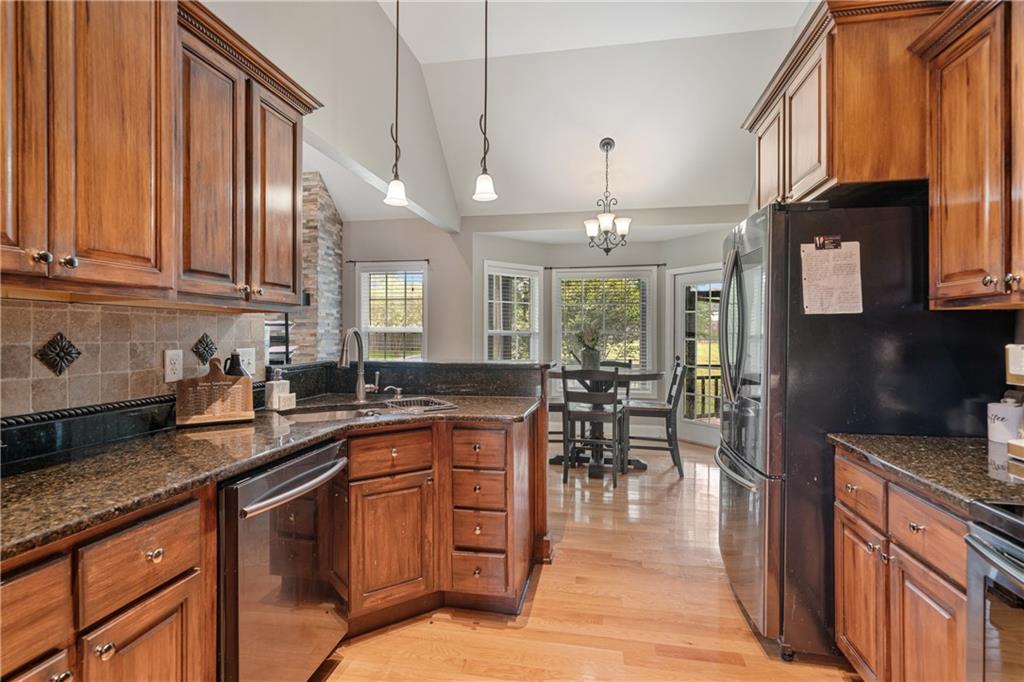 166 Woodford Way Southeast Calhoun, GA 30701 - Photo 17 of 44 a kitchen with lots of counter top space and dining table