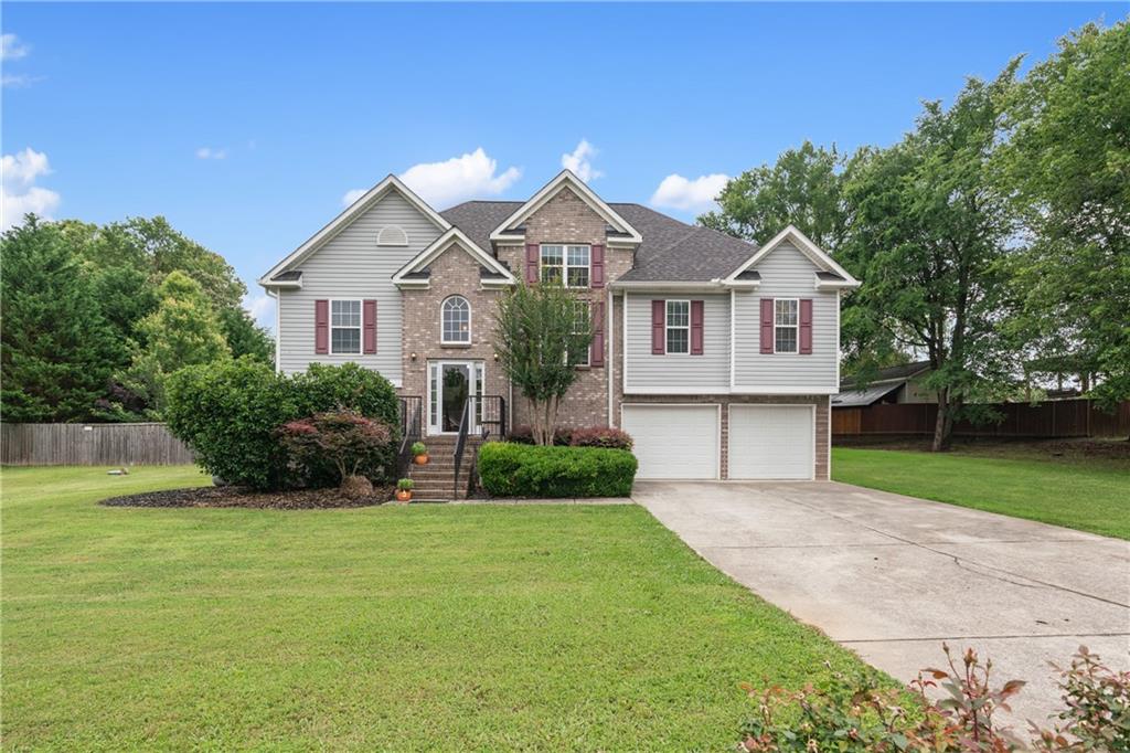 166 Woodford Way Southeast Calhoun, GA 30701 - Photo 2 of 44 a front view of a house with a garden and yard