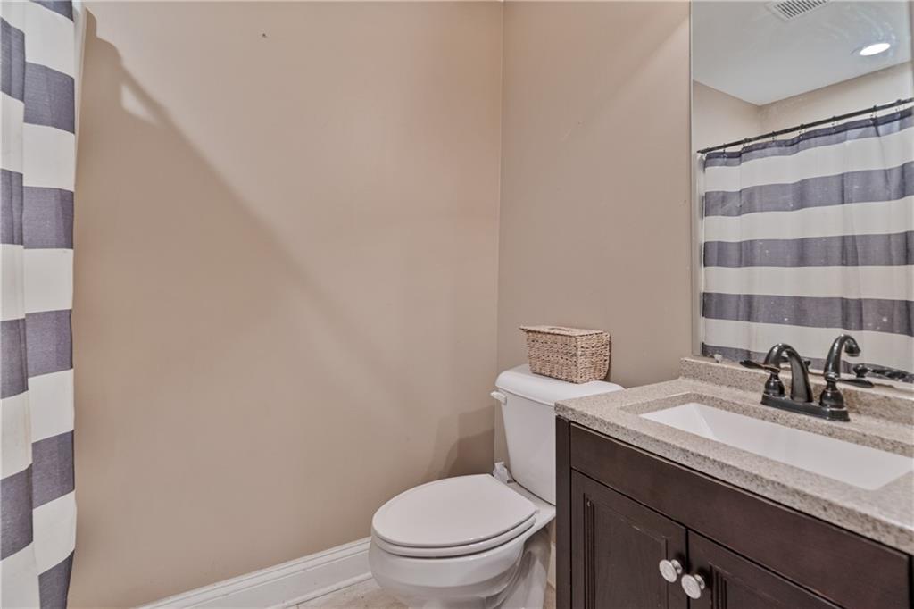 166 Woodford Way Southeast Calhoun, GA 30701 - Photo 31 of 44 a bathroom with a toilet a sink and mirror