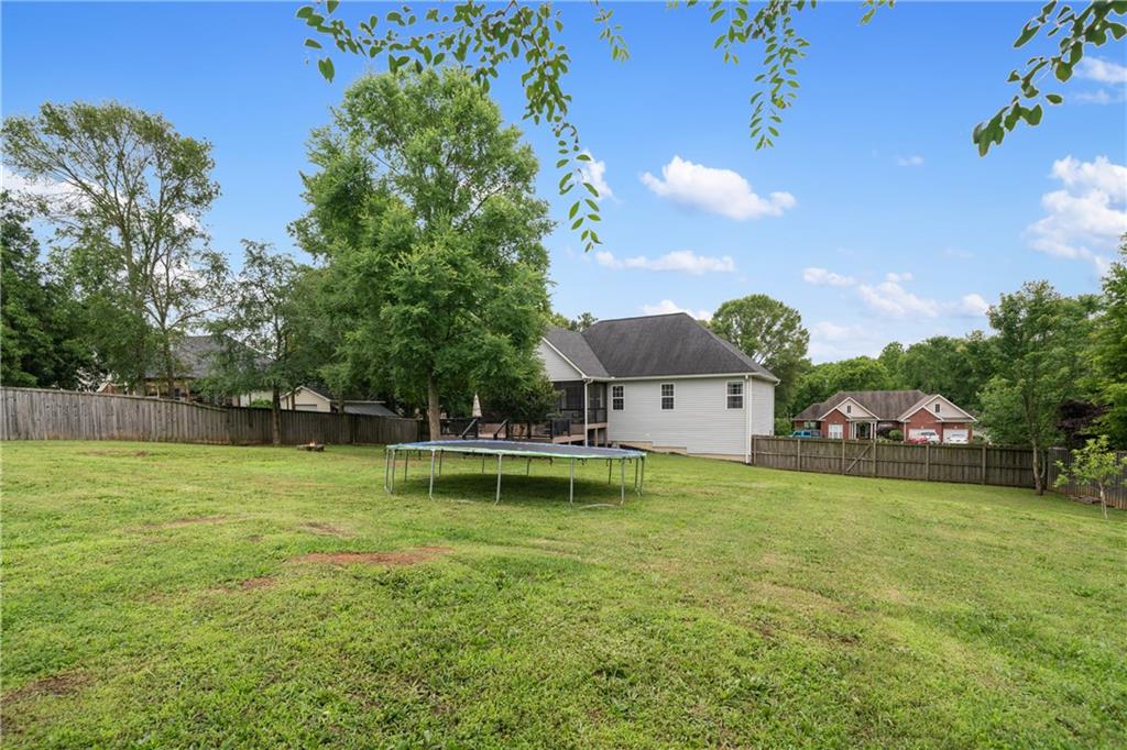 166 Woodford Way Southeast Calhoun, GA 30701 - Photo 41 of 44 a view of a house with a big yard and a large tree