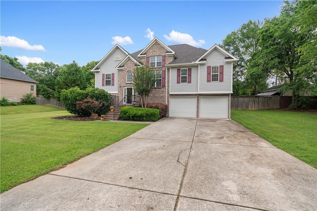 166 Woodford Way Southeast Calhoun, GA 30701 - Photo 43 of 44 a front view of a house with a garden and yard