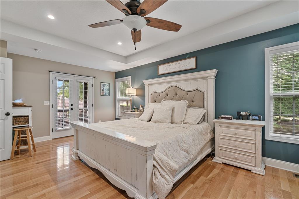 166 Woodford Way Southeast Calhoun, GA 30701 - Photo 5 of 44 a bedroom with a large bed and a chandelier