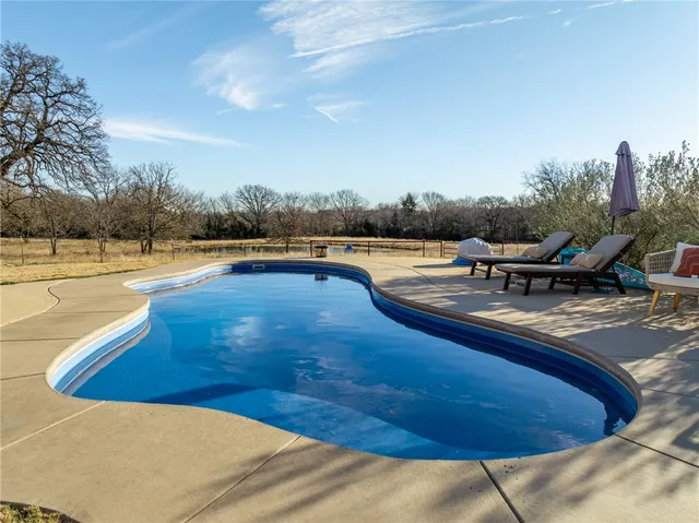 a view of a house with backyard and porch