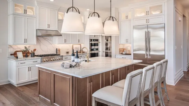 a kitchen with stainless steel appliances kitchen island granite countertop a sink and cabinets