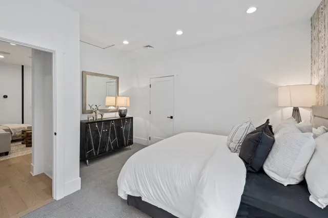 a spacious bedroom with a bed and a view living room