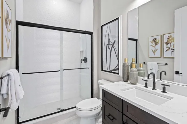a bathroom with a sink toilet and shower