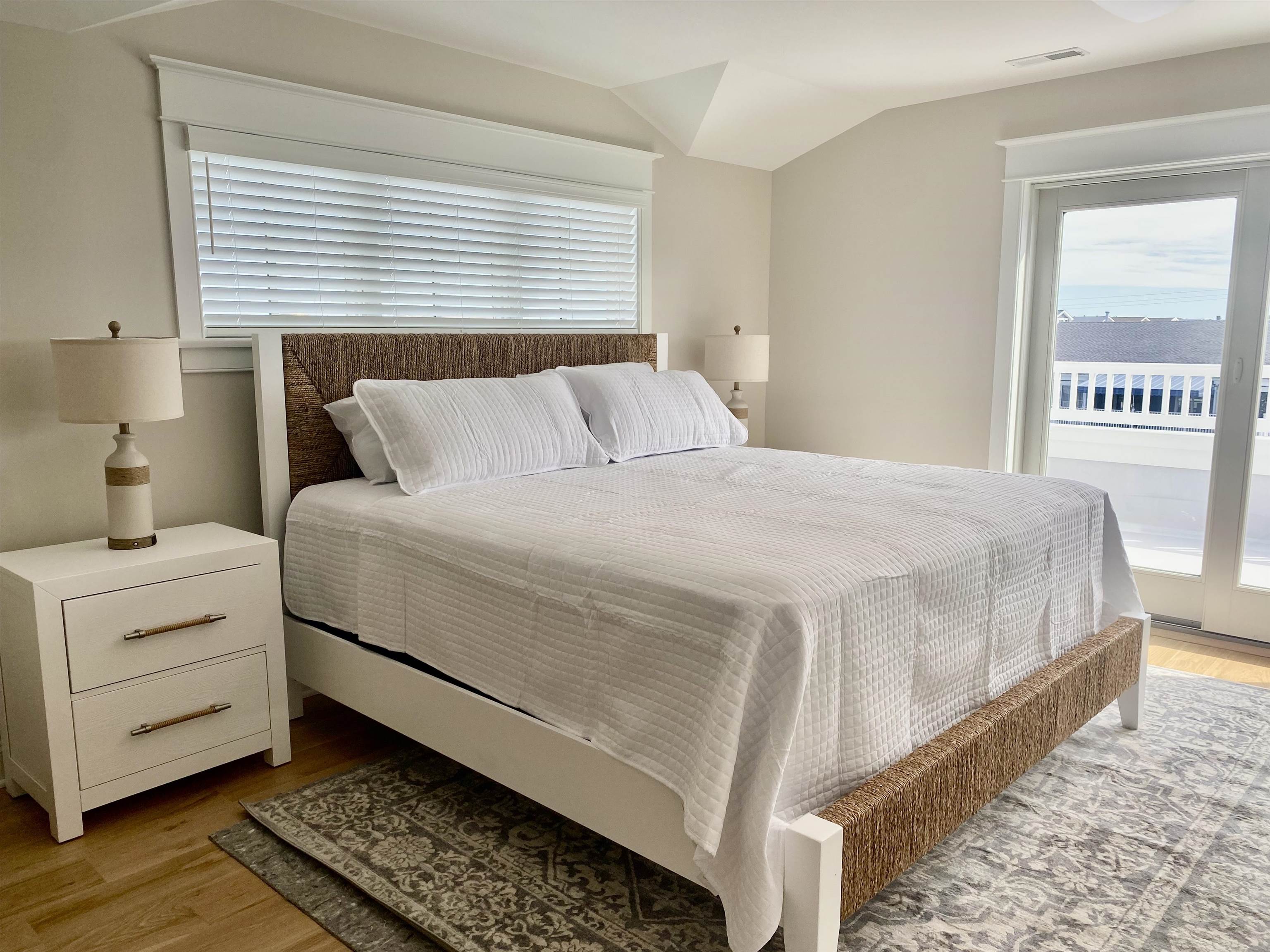 2425 Harbor, Unit 2425 Avalon, NJ 08202 - Photo 27 of 46 a bedroom with a bed and a window