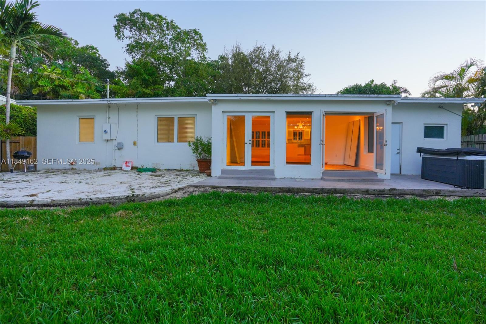 355 Redwood Lane Key Biscayne, FL 33149 - Photo 11 of 34 a front view of house with yard nad seating space