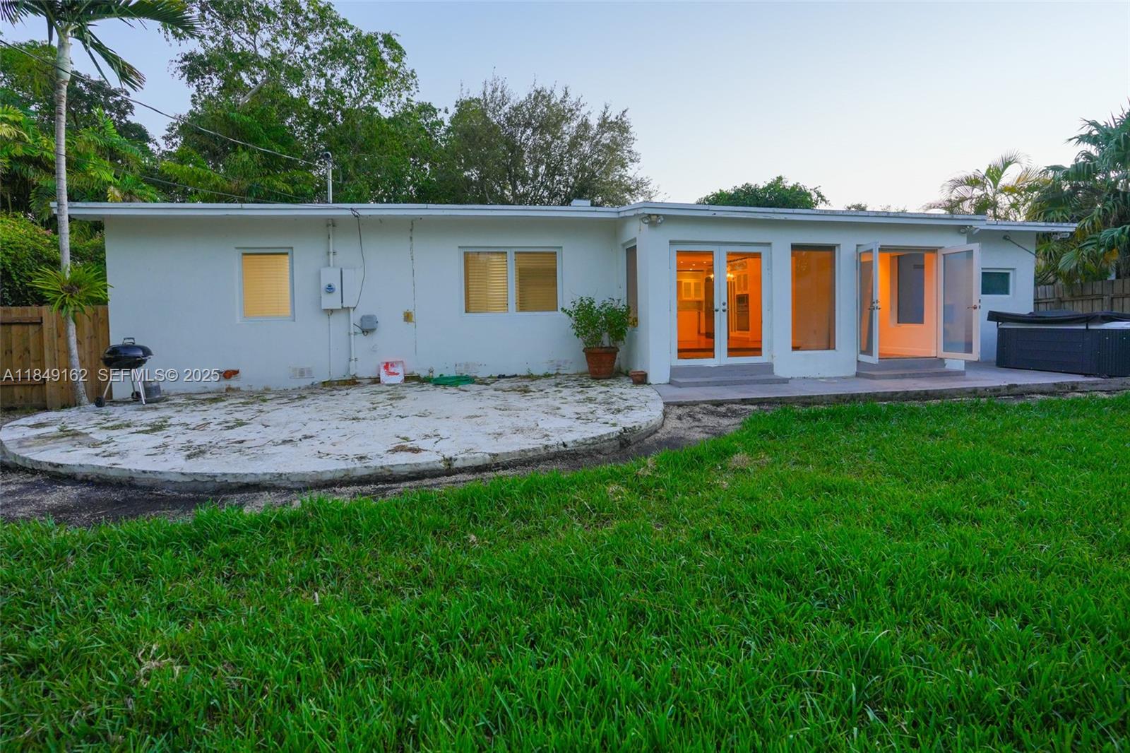 355 Redwood Lane Key Biscayne, FL 33149 - Photo 12 of 34 a view of a house with a backyard