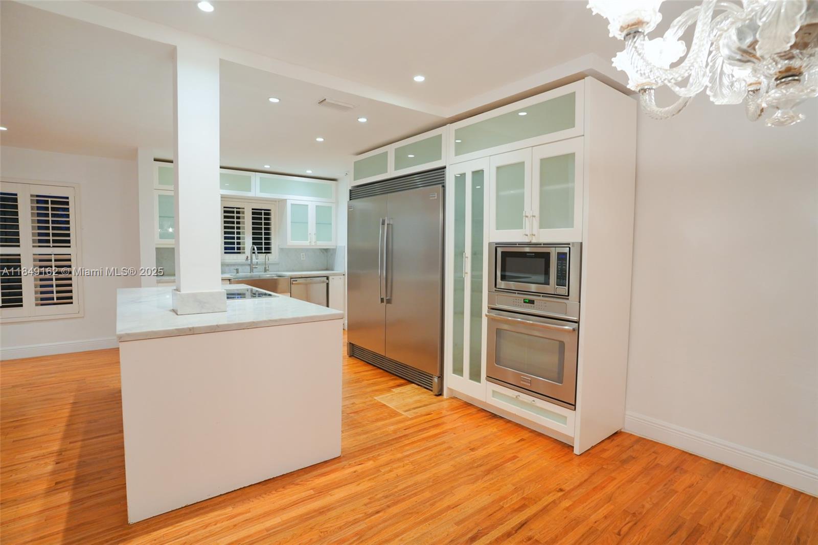 355 Redwood Lane Key Biscayne, FL 33149 - Photo 21 of 34 a kitchen with stainless steel appliances granite countertop a refrigerator a stove and a wooden floors