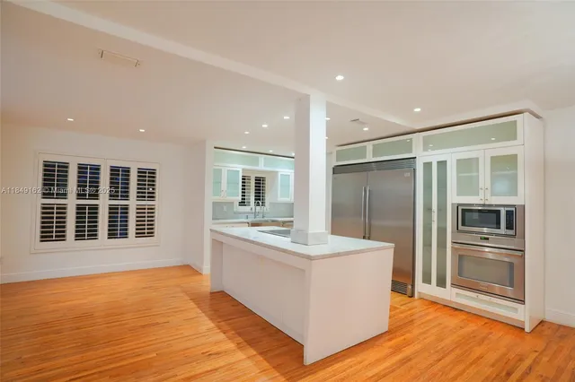 a bathroom with a sink double vanity and a large mirror