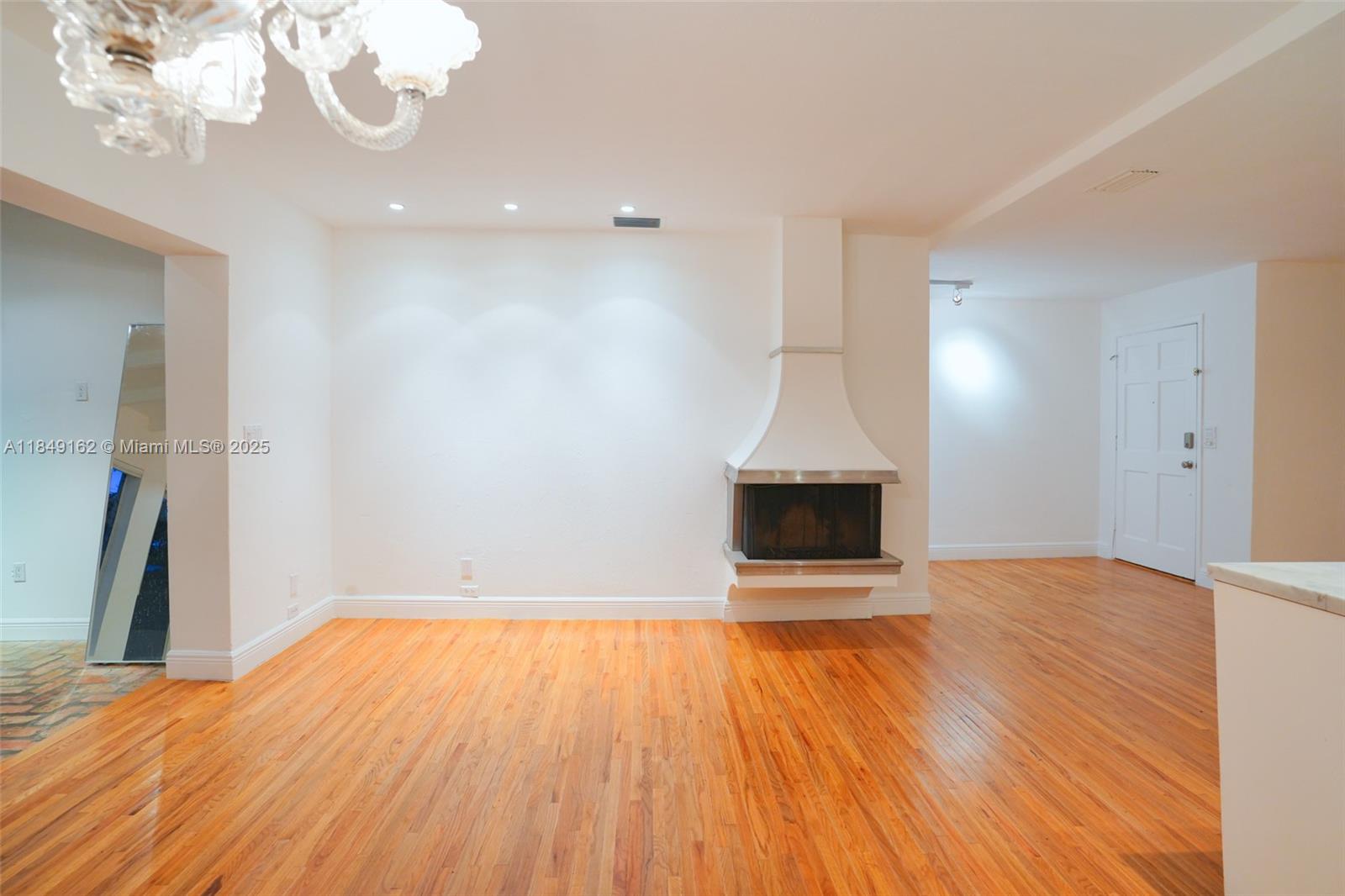 355 Redwood Lane Key Biscayne, FL 33149 - Photo 23 of 34 a view of empty room with wooden floor and fireplace
