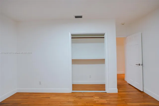 a view of room with wooden floor