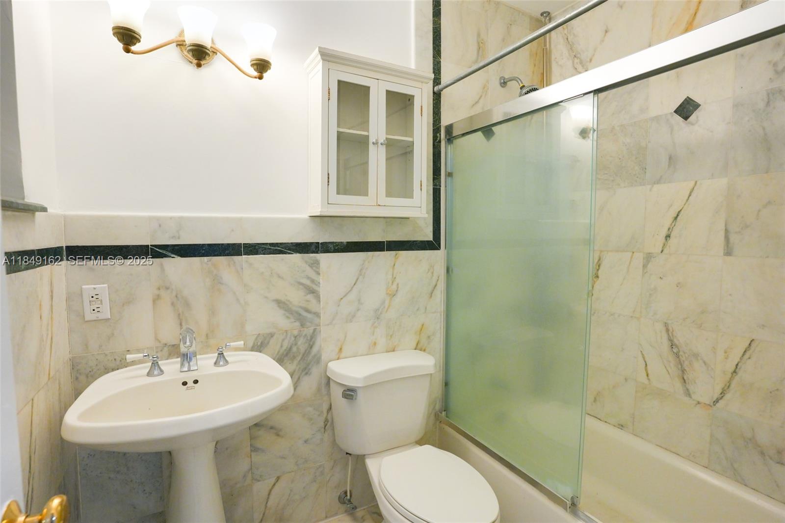 355 Redwood Lane Key Biscayne, FL 33149 - Photo 33 of 34 a bathroom with a sink mirror toilet and shower