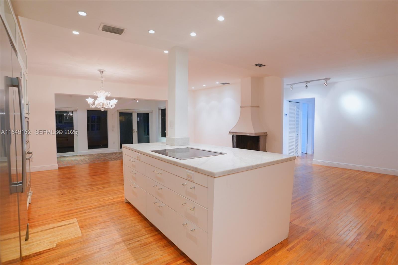 355 Redwood Lane Key Biscayne, FL 33149 - Photo 34 of 34 a large kitchen with stainless steel appliances kitchen island a large counter top and a wooden floors