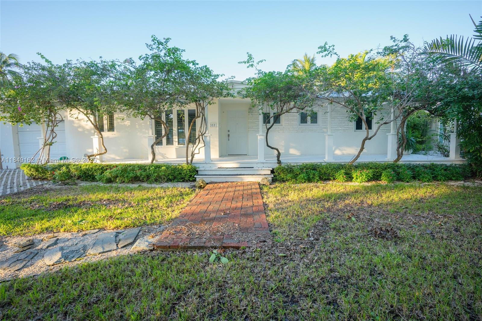 355 Redwood Lane Key Biscayne, FL 33149 - Photo 7 of 34 a front view of a house with garden