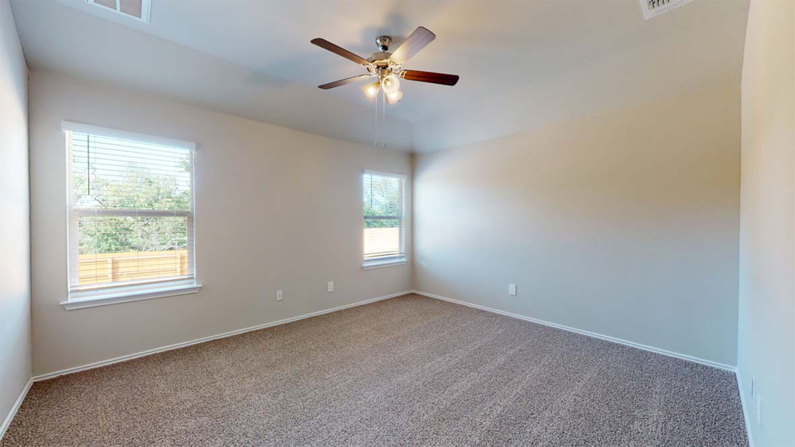 1403 Victory Rnch Trail Killeen, TX 76549 - Photo 12 of 22 This room features two windows, a ceiling fan with integrated lighting, and carpeted flooring