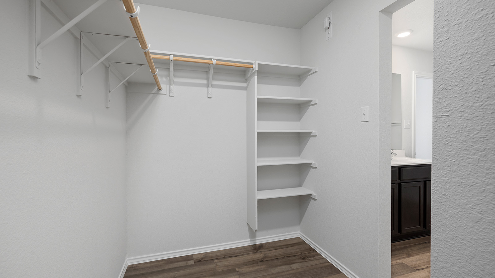 1403 Victory Rnch Trail Killeen, TX 76549 - Photo 16 of 22 This closet features built-in shelving, hanging rods, and wood-look flooring