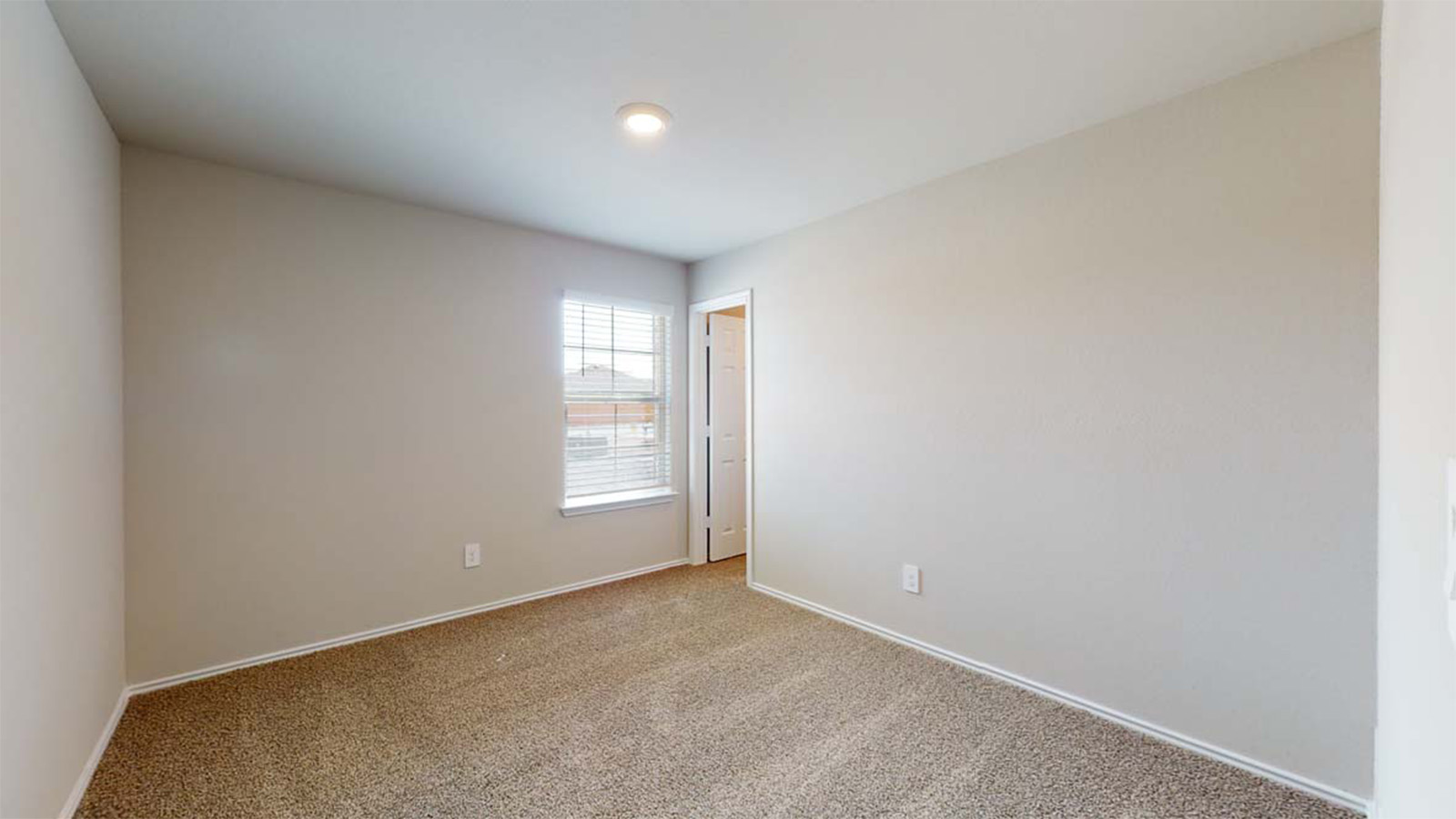 1403 Victory Rnch Trail Killeen, TX 76549 - Photo 17 of 22 The property features an empty room with a window providing exterior views, carpeted flooring, and a ceiling light fixture