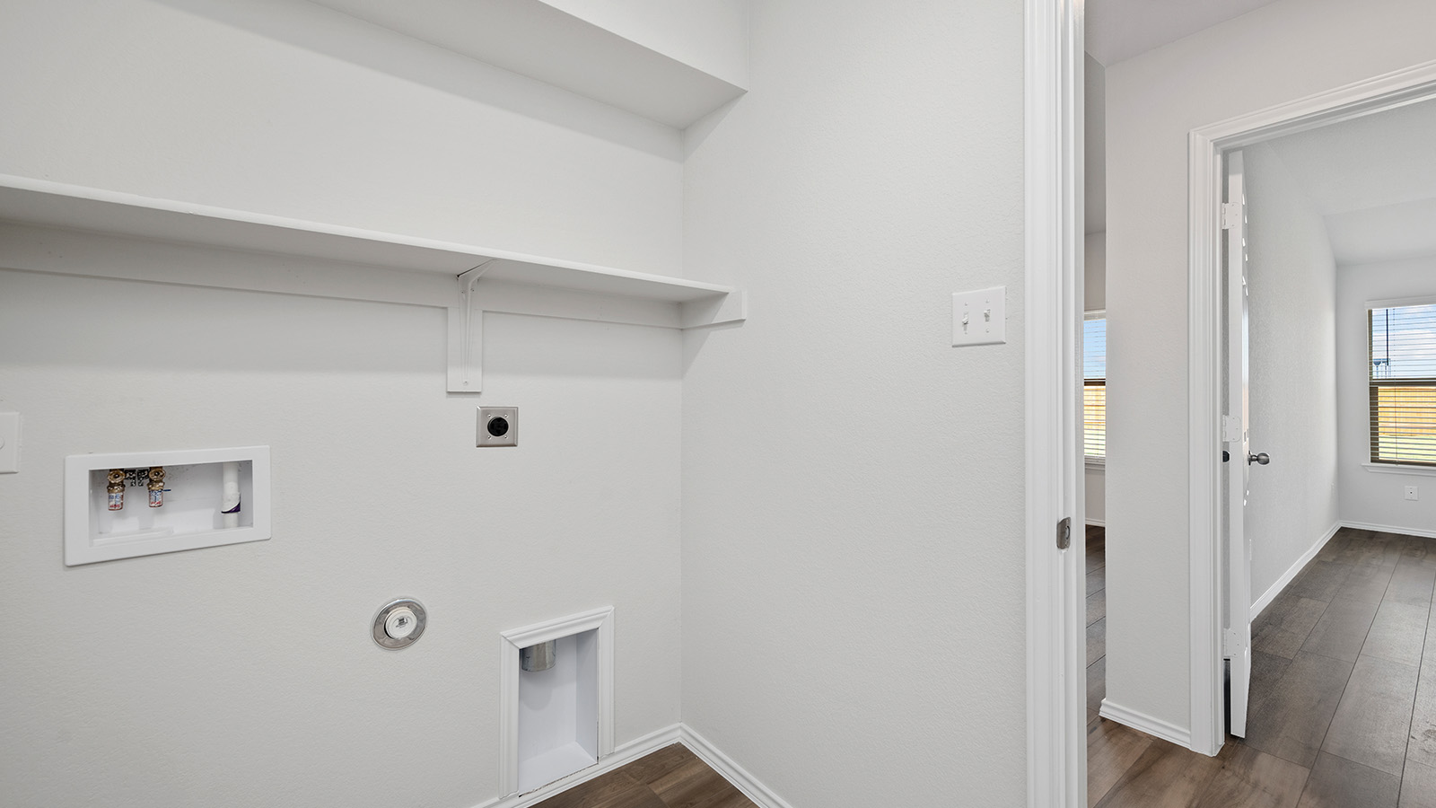 1403 Victory Rnch Trail Killeen, TX 76549 - Photo 21 of 22 Utility area featuring a white wall shelf, appliance connections, and wood-look flooring