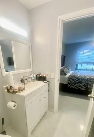 a bedroom with a bed and a mirror