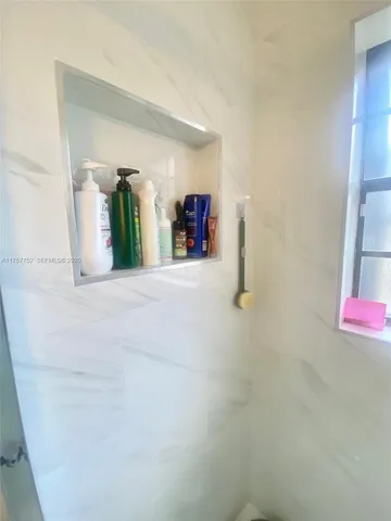 a view of a hallway with wooden shelves