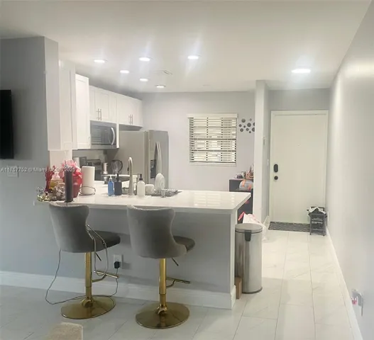 a kitchen with a sink cabinets and window