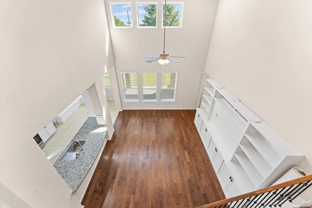 a view of a hallway view with wooden floor and staircase