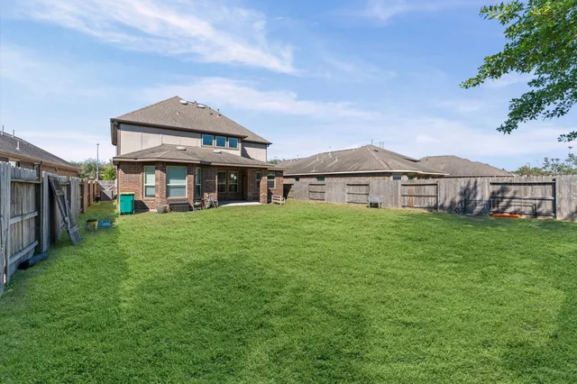 a aerial view of a house with a yard table and chairs