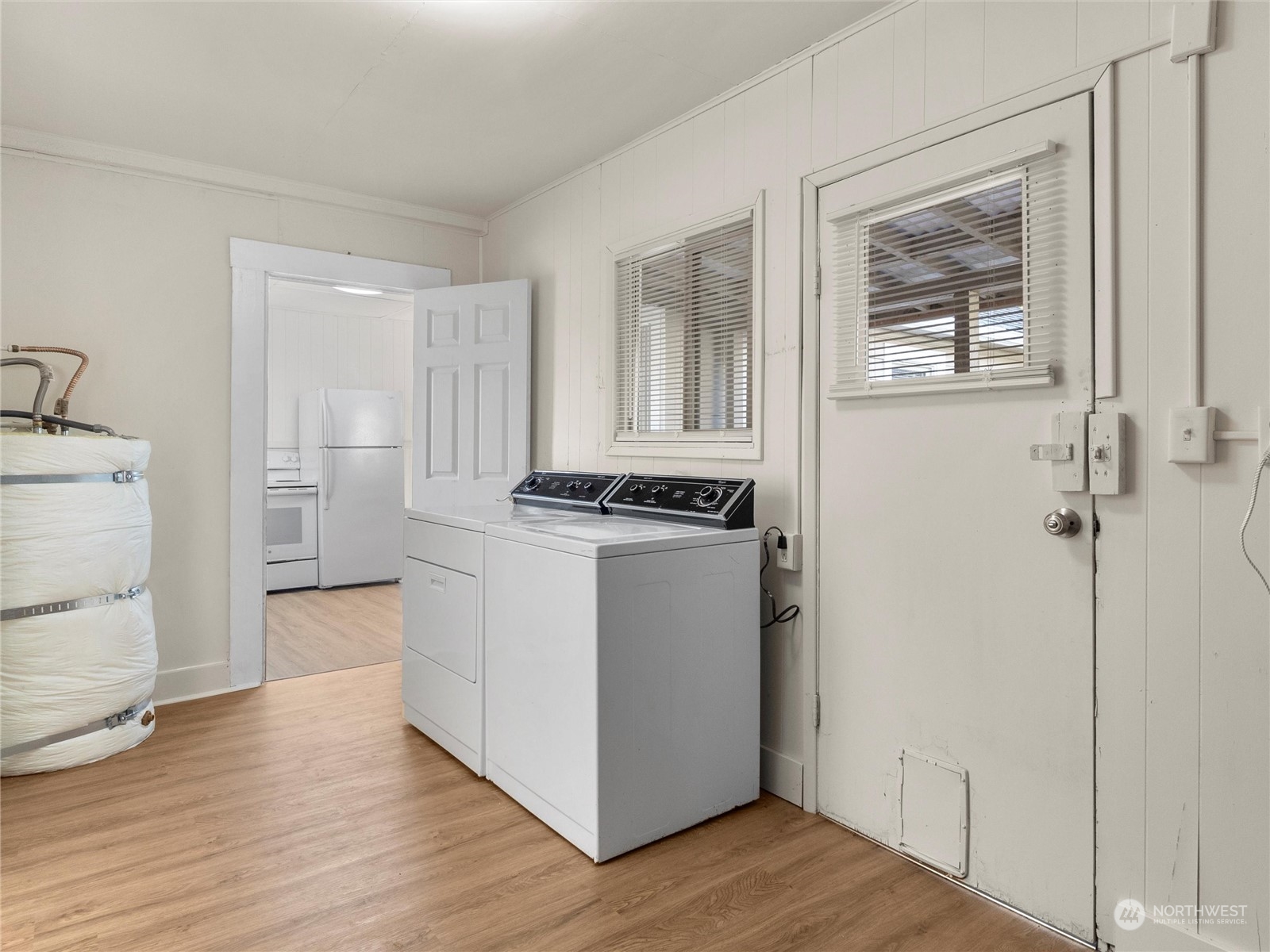 2304 Sumner Avenue Aberdeen, WA 98520 - Photo 22 of 31 a view of a kitchen with white cabinets and wooden floor