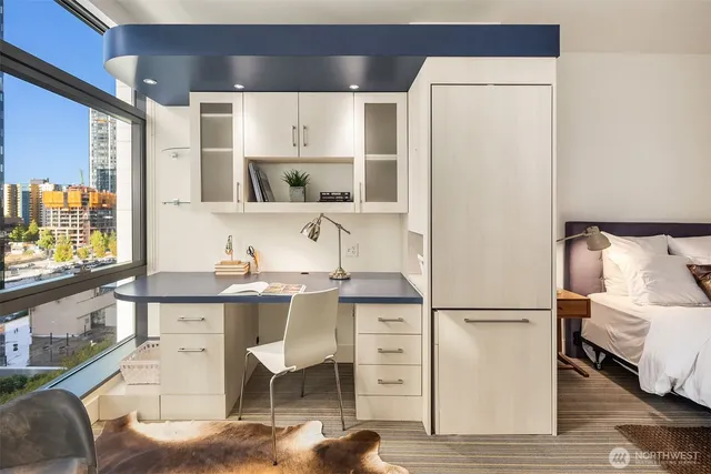 a room with a chair and white walls with wooden floor