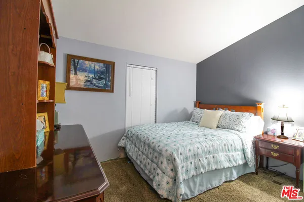 a bedroom with bed and a night stand